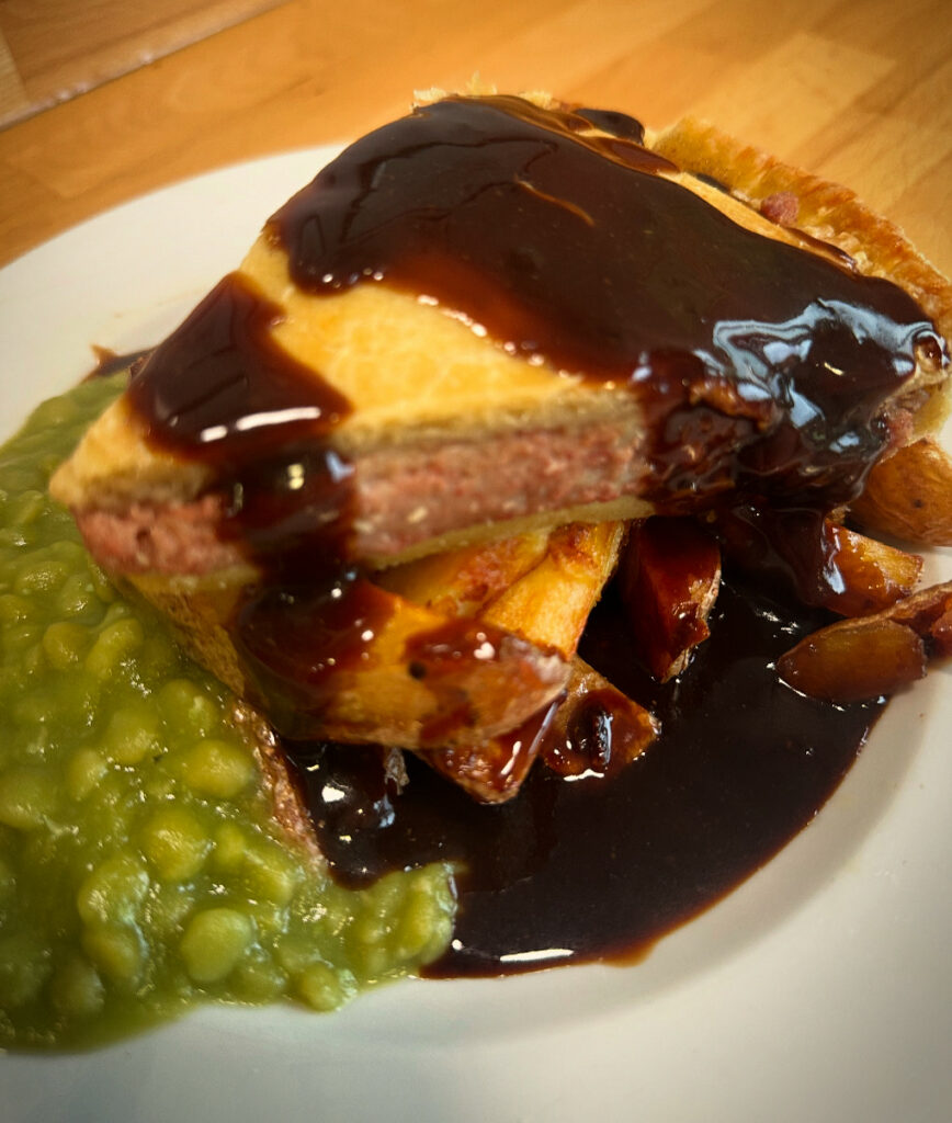 A photo of corned beef pie, homemade chips and mushy peas. There's something new every day! Pop in and see what’s cooking