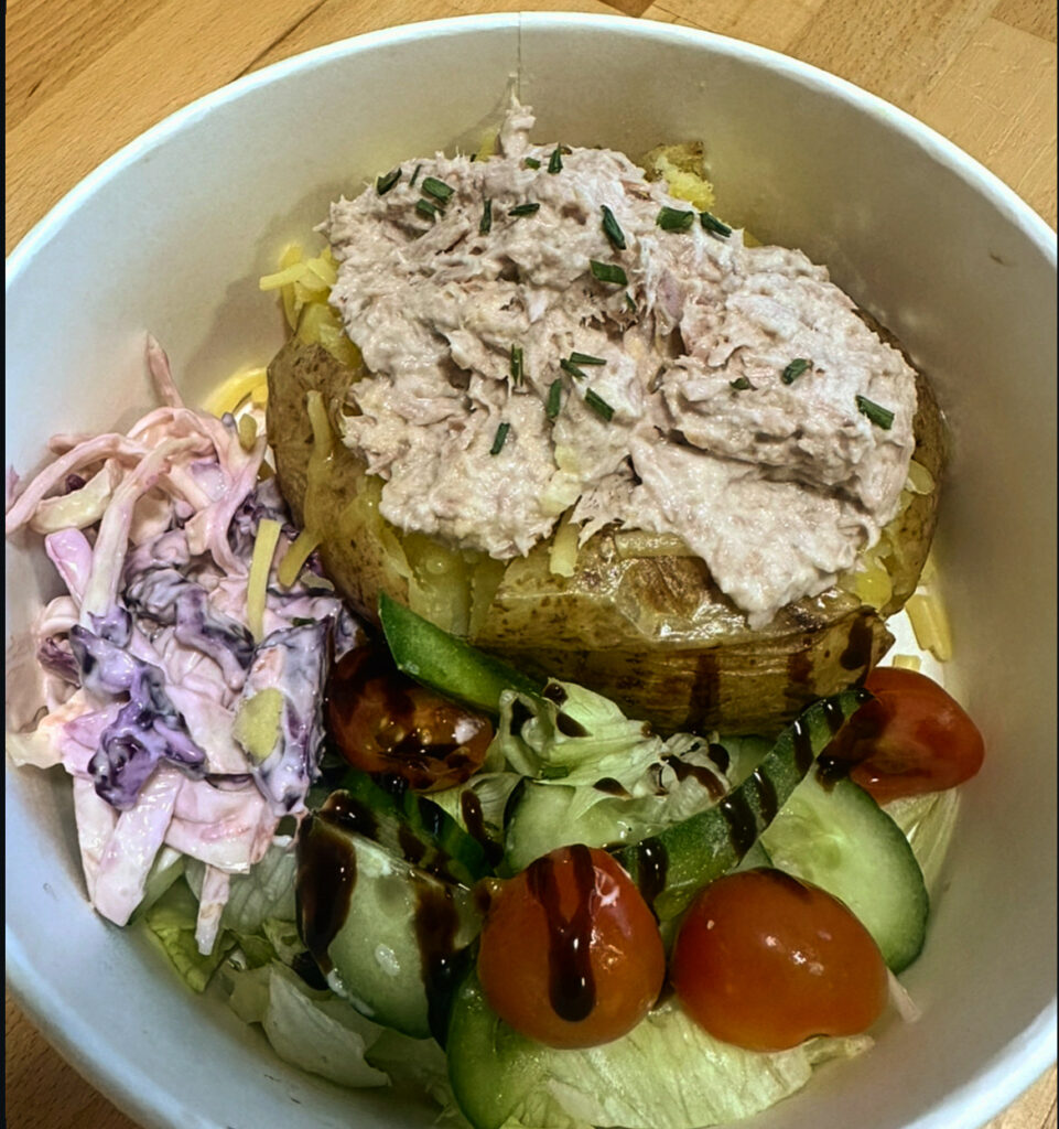 A photo of a jacket potato with tuna mayo and salad